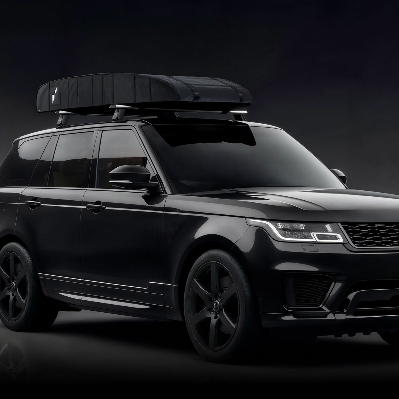 Twistboxes roof box mounted on black car with universal roof rack